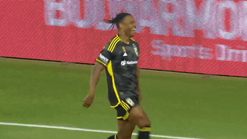 Two Soccer Players On A Field With A Lowe Sign Behind Them GIF