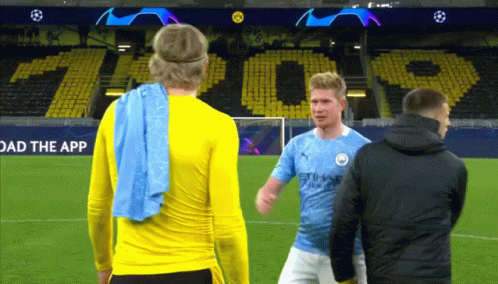 Two Soccer Players On A Field With A Sign That Says " Load The App " GIF