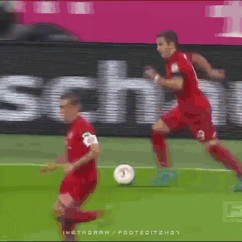 Two Soccer Players On A Field With A Sign That Says T-Mobile GIF