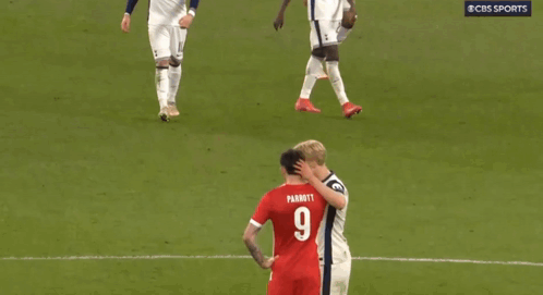 two soccer players on a field with one wearing a number 9