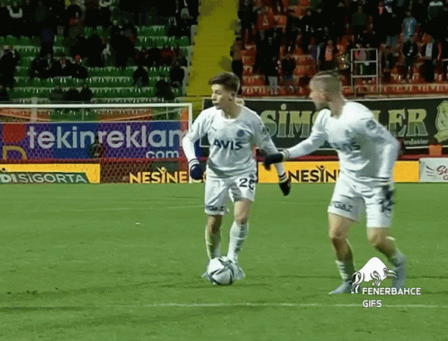 Two Soccer Players on Field With Tekinreklam Sign