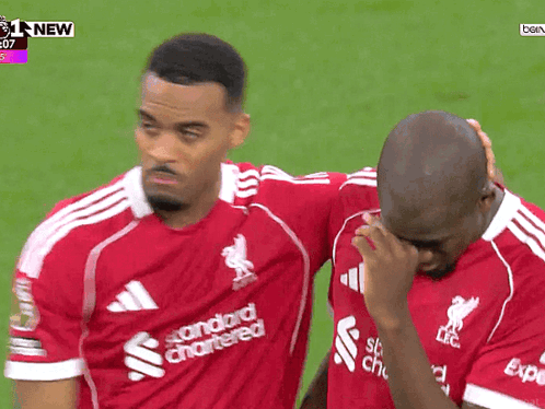 Two Soccer Players One in Red Standard Chartered Shirt