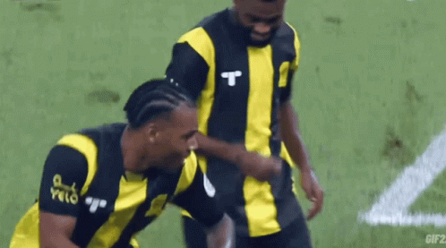 Two Soccer Players One with Letter T