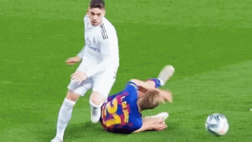 Two Soccer Players Playing Field One Lying
