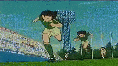 Two Soccer Players Running On Field With Crowd GIF