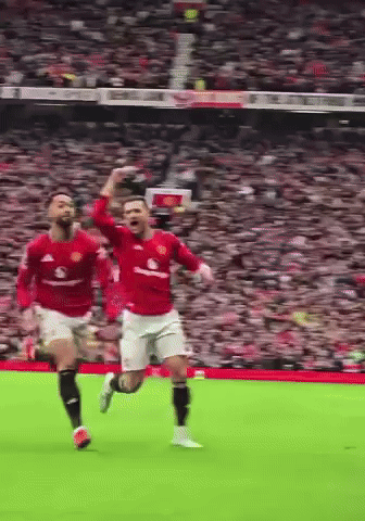 Two Soccer Players Running with Arms Up