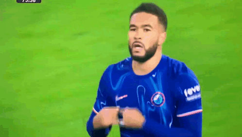 Two Soccer Players Shaking Hands With One Wearing A Fever Shirt GIF