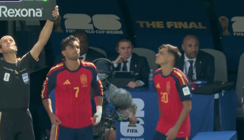 Two Soccer Players Stand In Front Of A Fifa World Cup Sign GIF