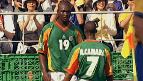 two soccer players standing next to each other with one wearing a number 7 jersey