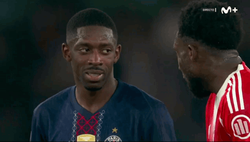 Two Soccer Players Talking on Soccer Field