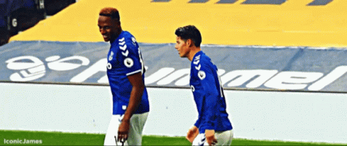 Two Soccer Players Walking On Field With Iconic James GIF