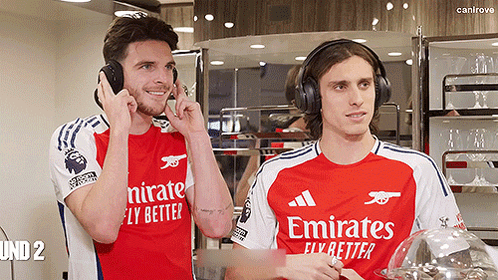 Two Soccer Players Wearing Emirates Shirts GIF