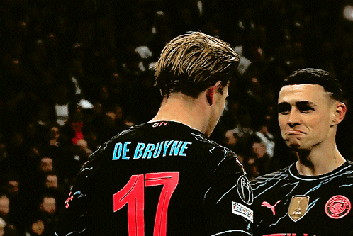 Two Soccer Players Wearing Etihad Jerseys Are Talking GIF