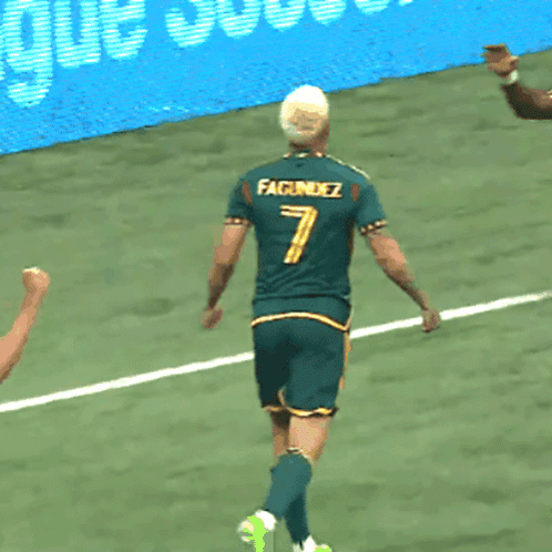 Two Soccer Players Wearing Green Jerseys With The Number 7 And 28 On Them GIF