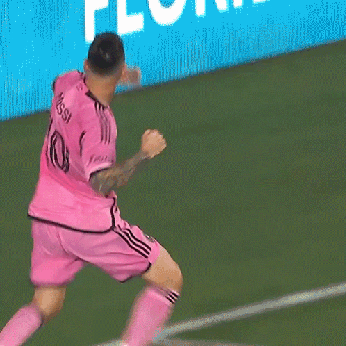 Two Soccer Players Wearing Pink Jerseys Hugging Each Other GIF