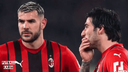 Two Soccer Players Wearing Red And Black Striped Shirts With Karim Written On Them GIF