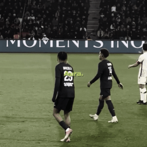 Two Soccer Players With Banner Saying Moments Inu