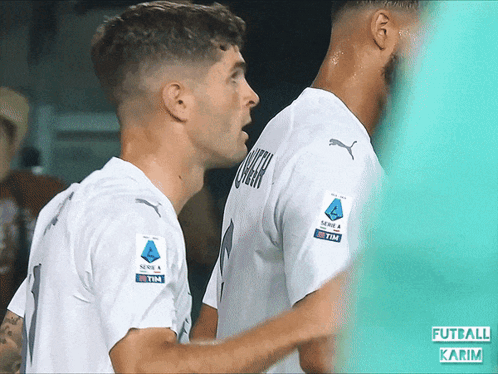 Two Soccer Players With Tim on Shirt