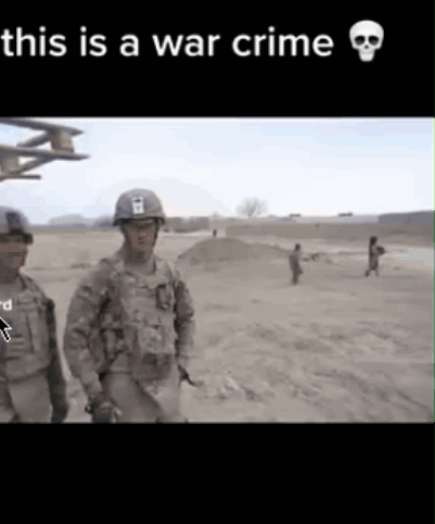 Two Soldiers Are Standing In A Field With The Words This Is A War Crime GIF