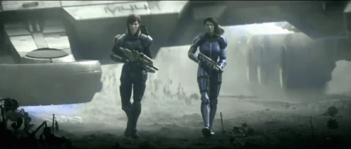 Two Soldiers Are Walking In Front Of A Ship That Says M4u GIF