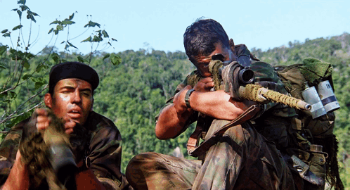 Two Soldiers One Of Whom Is Holding A Sniper Rifle With The Letter R On It GIF