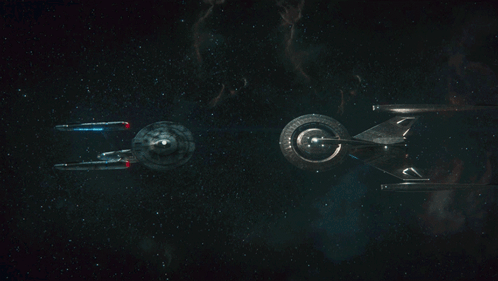 Two Spaceships Flying In Dark GIF