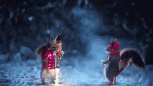 Two Squirrels Standing in Snow in Christmas Clothes