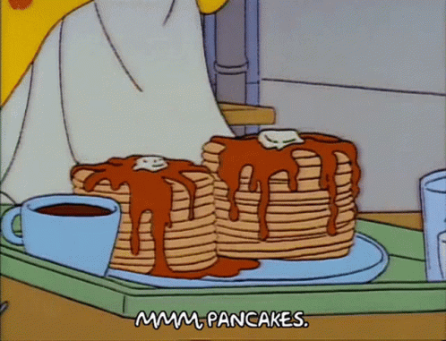 Two Stacks Of Pancakes Are On A Tray With A Cup Of Coffee GIF