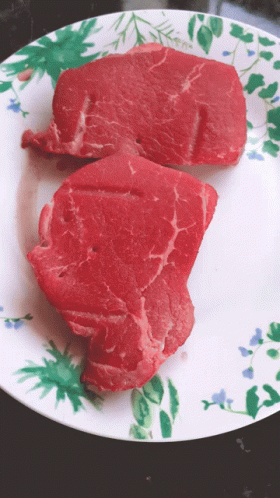 Two Steaks On Paper Plate With Flowers And Leaves GIF