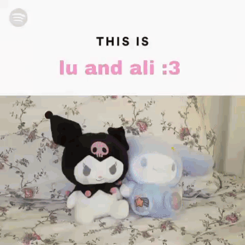 Two Stuffed Animals Are Sitting Next To Each Other On A Bed With Flowers On It . GIF