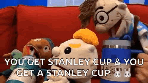 Two Stuffed Animals Are Sitting On A Couch And One Of Them Is Holding A Stanley Cup GIF