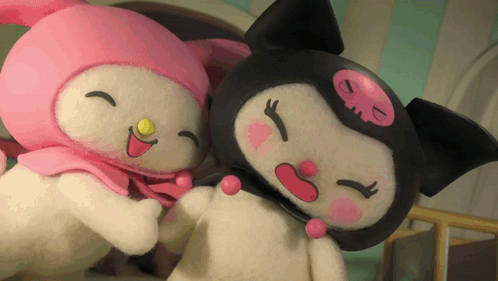 two stuffed animals are standing next to each other and one has a smiley face