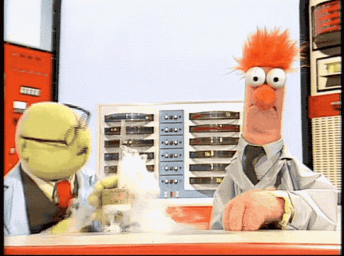 Two Stuffed Animals Are Standing Next To Each Other And One Of Them Has A Red Haired Face GIF