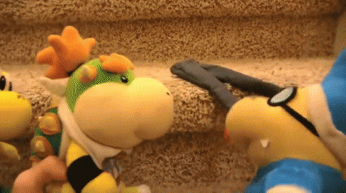 Two Stuffed Animals Are Standing Next To Each Other On A Staircase GIF