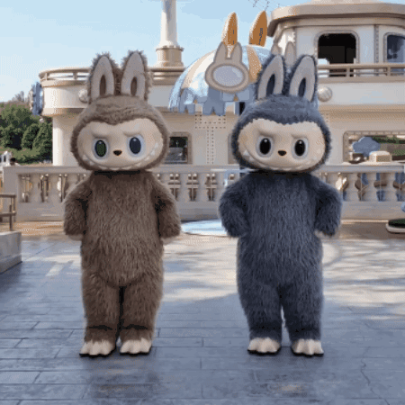 Two Stuffed Animals Are Standing Next To Each Other GIF