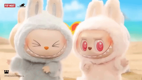 Two Stuffed Animals on Beach With Pop Mart Logo