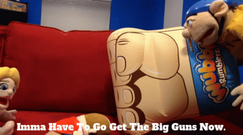Two Stuffed Animals On Red Couch With Rumbler Balloon GIF