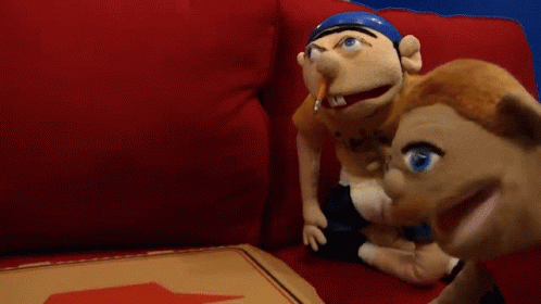 Two Stuffed Animals Sit On A Red Couch Next To A Pizza Box GIF