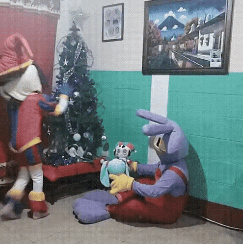 Two Stuffed Animals Sitting by Christmas Tree