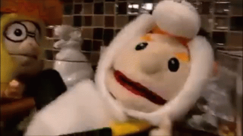 Two Stuffed Animals Standing Next to Each Other on Counter