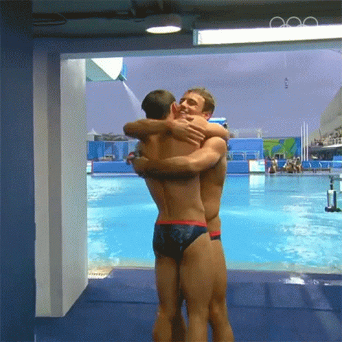 Two Swimmers Doing Bro Hug GIF