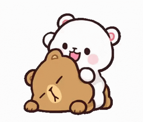 Two Teddy Bears Sitting Next To Each Other Looking