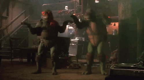 Two Teenage Mutant Ninja Turtles In Dark Room GIF