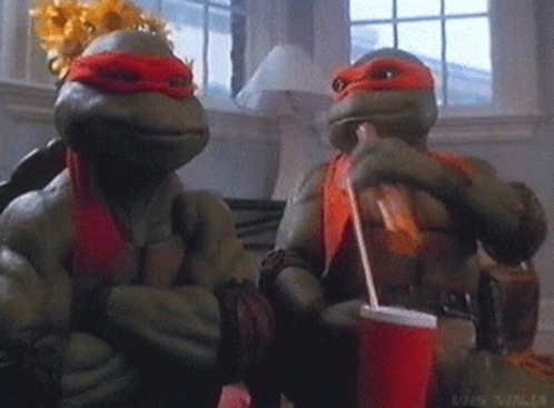 Two Teenage Mutant Ninja Turtles Sitting Next To Each Other Drinking Soda GIF