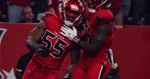 Two Texans Players Are Hugging Each Other GIF