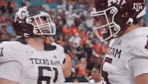 Two Texas A&M Football Players Talking on Field