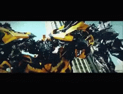 Two Transformers Fighting Yellow One GIF