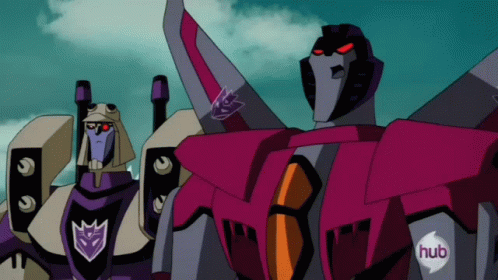 Two Transformers Standing With Hub Logo on Chests
