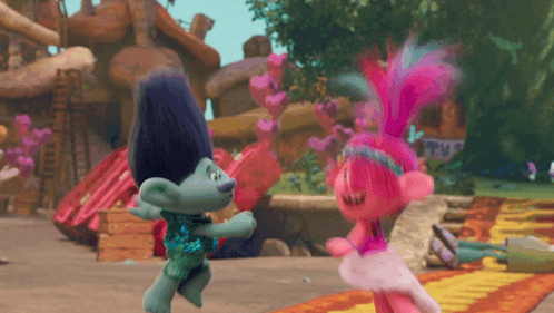 Two Trolls Dancing In Front Of A Sign That Says ' Trolls ' On It GIF