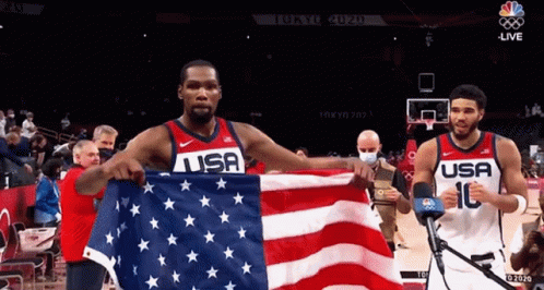 Two USA Basketball Players Holding American Flag